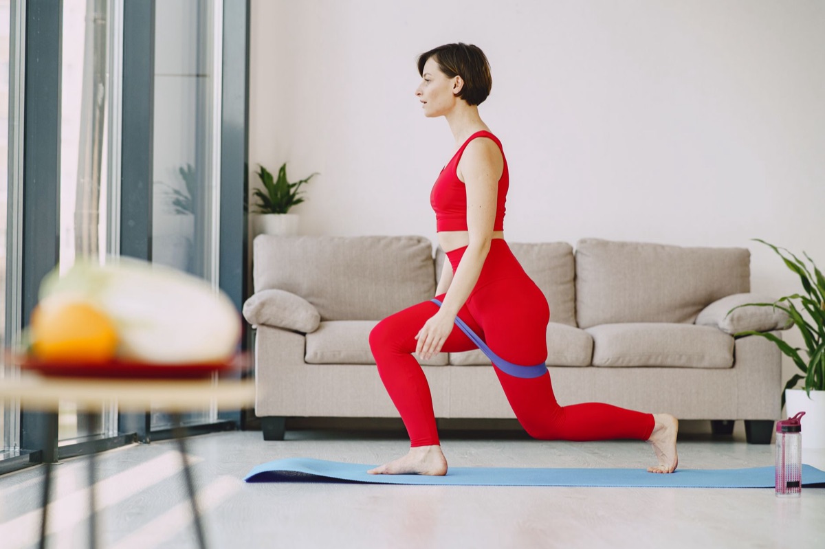 mujer haciendo squats en su casa