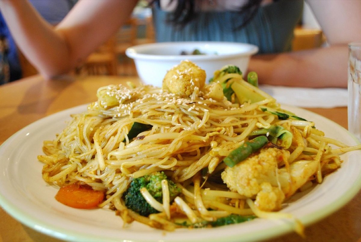 A healthy tofu and vegetable stir fry in a ceramic bowl.
